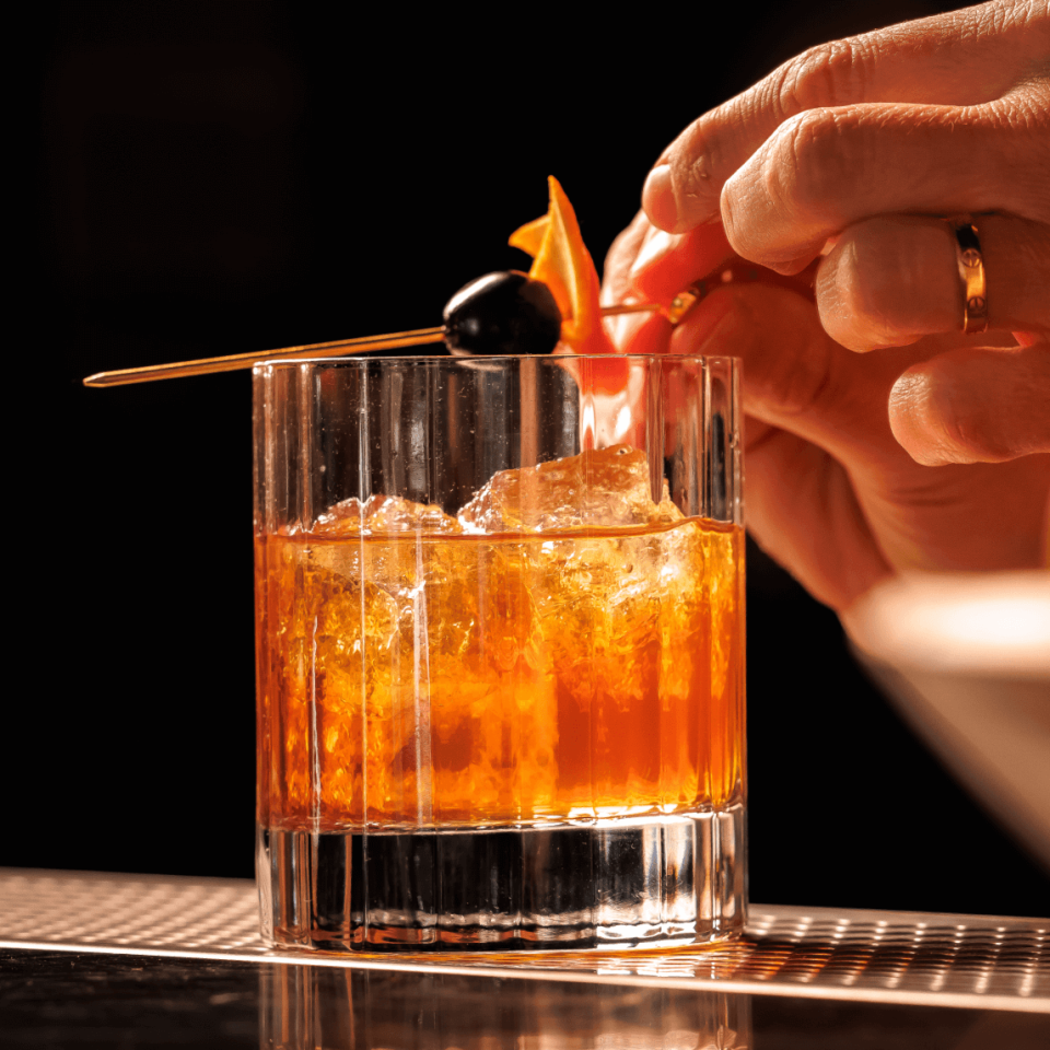 Whickey Cocktail with garnish on toothpick